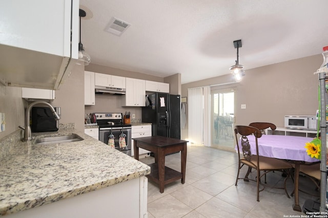 kitchen with stainless steel electric stove, sink, decorative light fixtures, white cabinetry, and black fridge