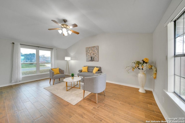 living room featuring vaulted ceiling, ceiling fan, and light hardwood / wood-style floors