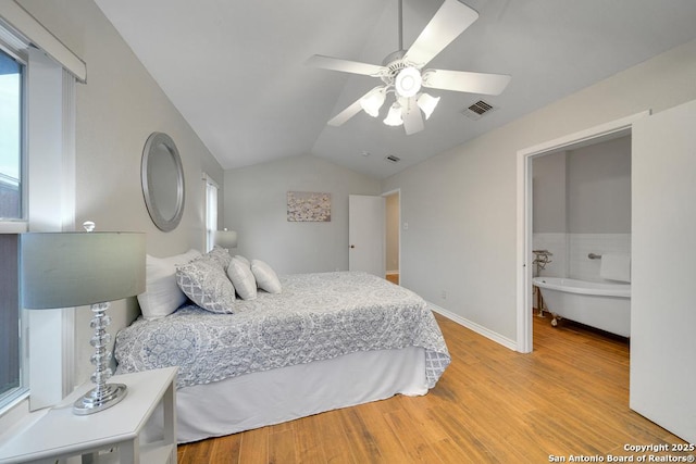 bedroom featuring ceiling fan, light hardwood / wood-style flooring, and vaulted ceiling