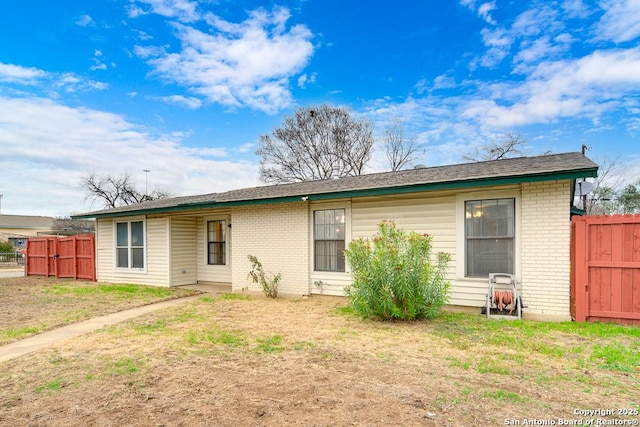 back of property featuring a lawn