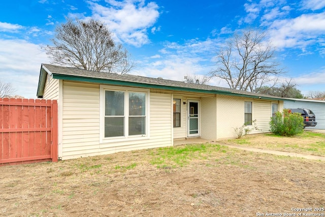 back of house with a lawn