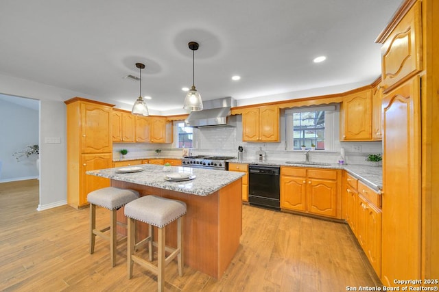 kitchen with dishwasher, sink, wall chimney exhaust hood, backsplash, and a kitchen island