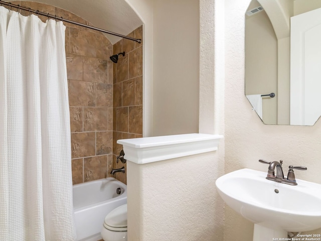 full bathroom with toilet, sink, and shower / bath combo with shower curtain