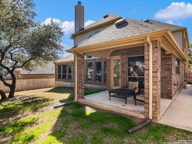 rear view of house with a lawn and a patio area