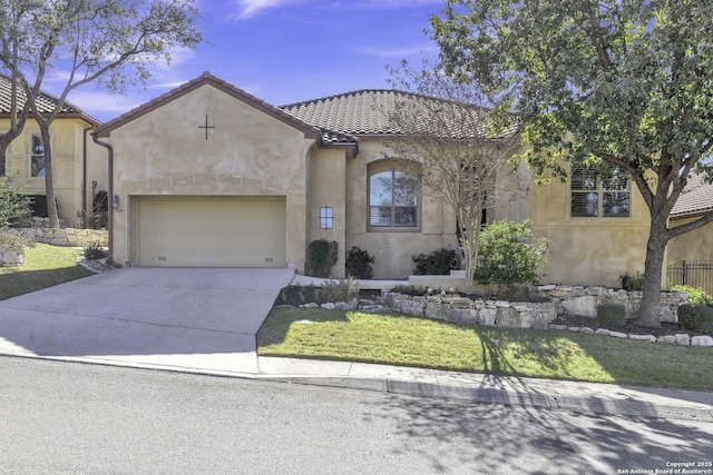 mediterranean / spanish home featuring a garage