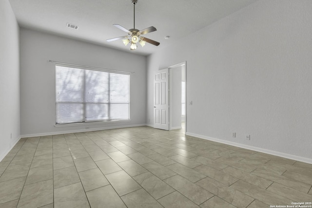 tiled empty room with ceiling fan