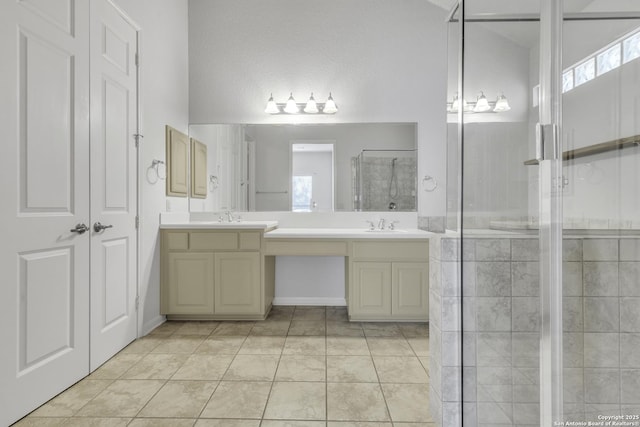 bathroom featuring tile patterned flooring, an enclosed shower, and vanity