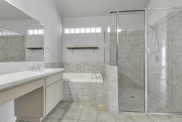 bathroom featuring independent shower and bath, vanity, and tile patterned flooring