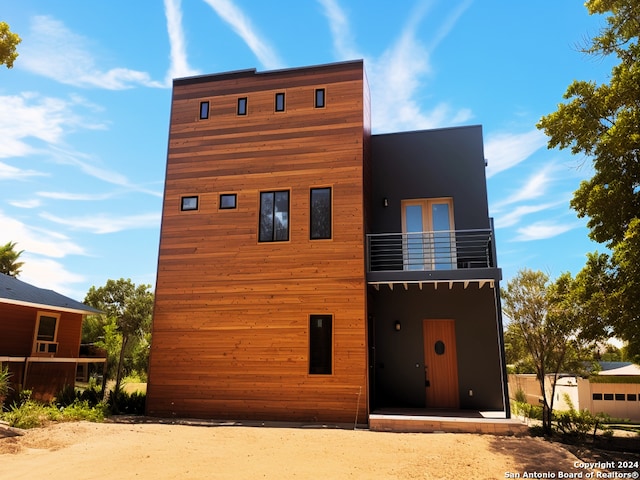 rear view of property with a balcony