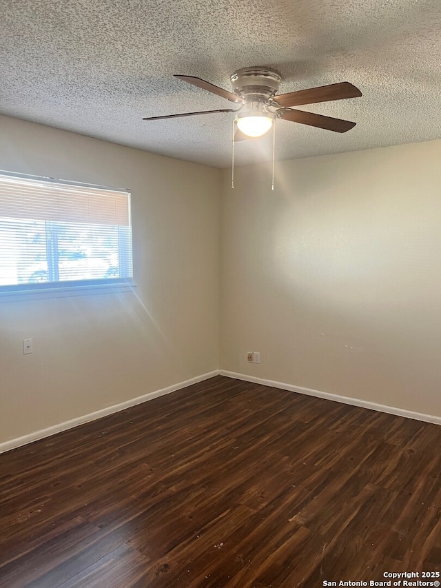 unfurnished room with ceiling fan, dark wood-type flooring, and a textured ceiling