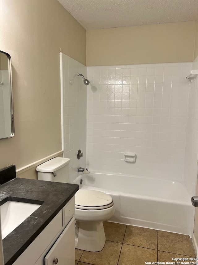 full bathroom with a textured ceiling, shower / bathing tub combination, tile patterned flooring, vanity, and toilet