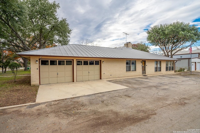 single story home with a garage and an outdoor structure