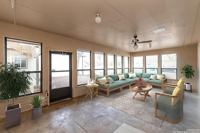 sunroom / solarium featuring ceiling fan