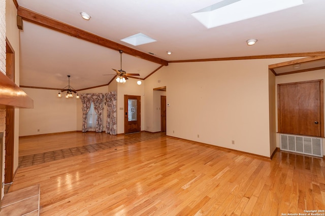 unfurnished living room with ceiling fan with notable chandelier, vaulted ceiling with skylight, and light wood-type flooring