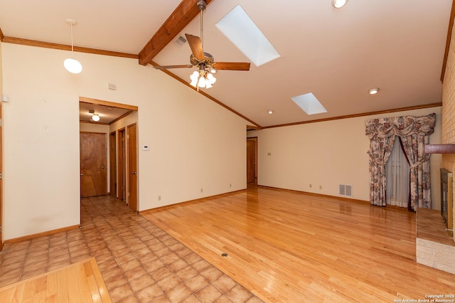 unfurnished living room featuring ceiling fan, lofted ceiling with skylight, ornamental molding, and light wood-type flooring