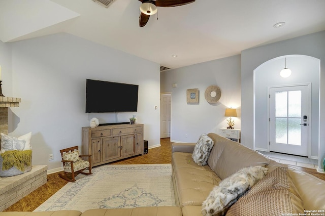 living room with vaulted ceiling, hardwood / wood-style floors, and ceiling fan