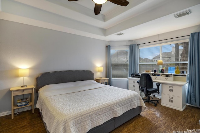 bedroom with dark hardwood / wood-style floors, a raised ceiling, and ceiling fan