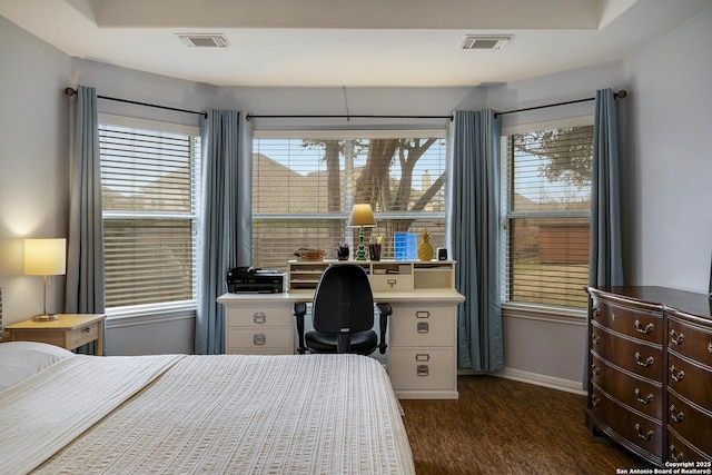 bedroom with dark hardwood / wood-style flooring and multiple windows