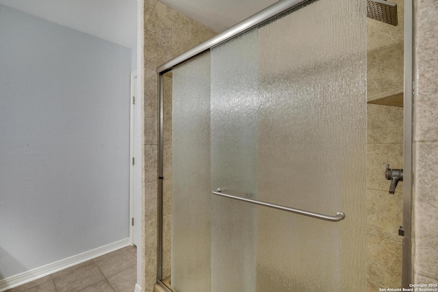 bathroom featuring tile patterned flooring and a shower with door