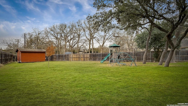 view of yard with a playground and a shed