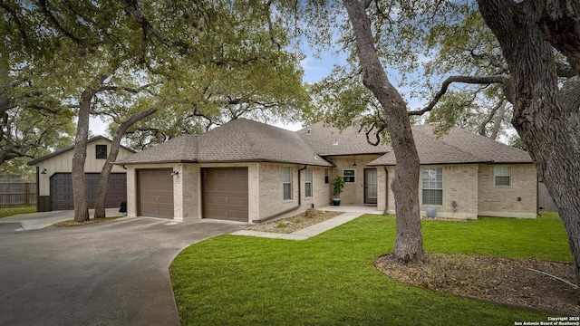 view of front facade with a garage and a front lawn