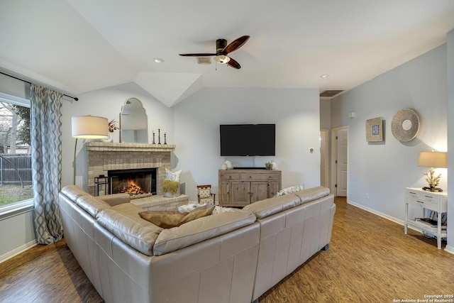 living room featuring vaulted ceiling, plenty of natural light, and light hardwood / wood-style floors