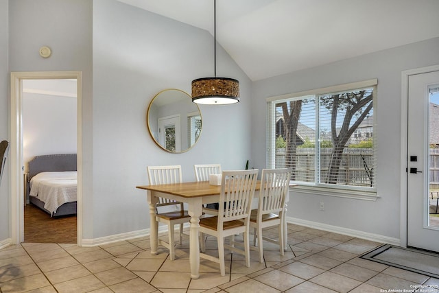 tiled dining area featuring lofted ceiling