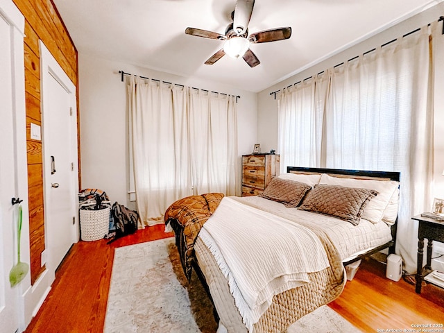 bedroom with ceiling fan and wood-type flooring