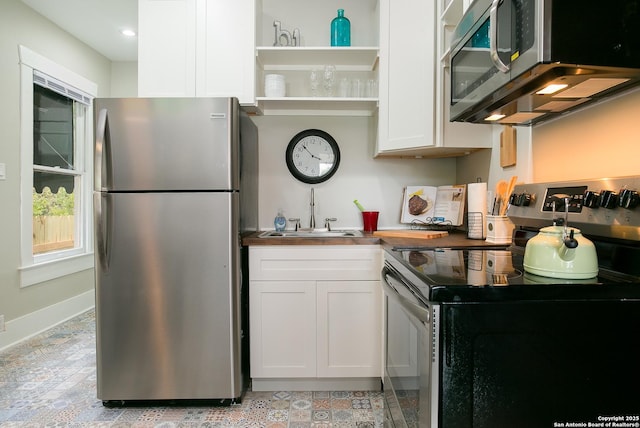 kitchen featuring sink, white cabinets, and appliances with stainless steel finishes