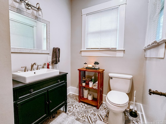 bathroom featuring toilet, tile patterned floors, and vanity