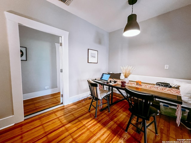 dining space with hardwood / wood-style flooring