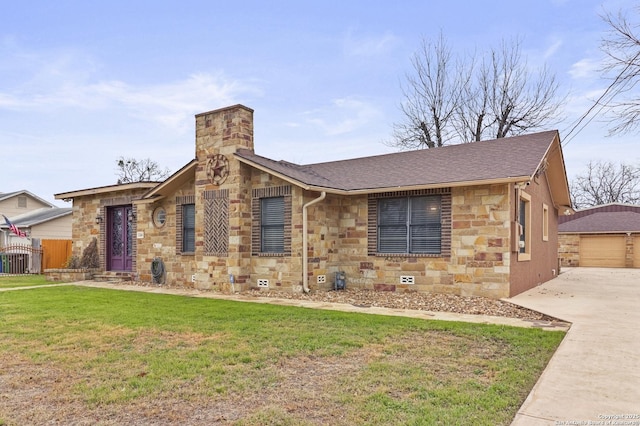 view of front facade with a garage, an outdoor structure, and a front lawn