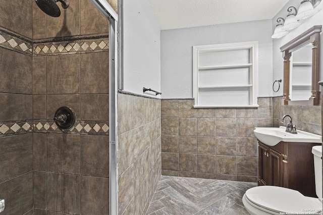 bathroom featuring tiled shower, toilet, tile walls, and a textured ceiling