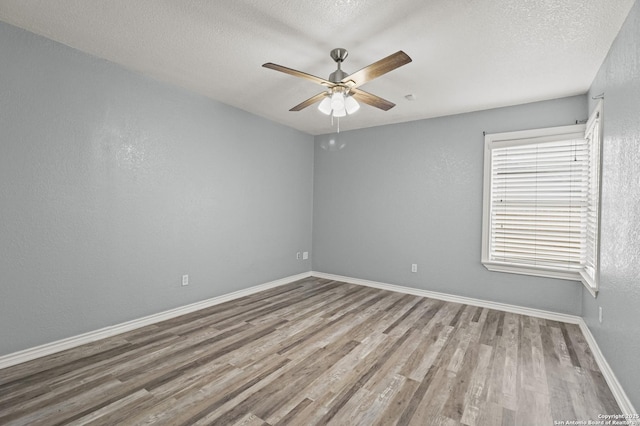 empty room with light hardwood / wood-style floors, a textured ceiling, and ceiling fan