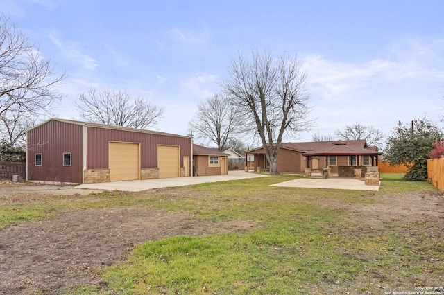 view of yard with a patio, an outdoor structure, and a garage