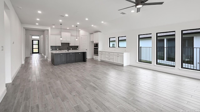 kitchen with open floor plan, visible vents, a wealth of natural light, and a sink