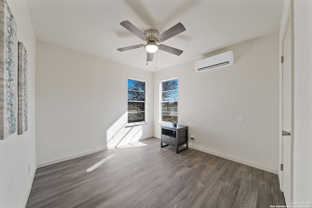 empty room with ceiling fan, dark hardwood / wood-style floors, and a wall mounted AC