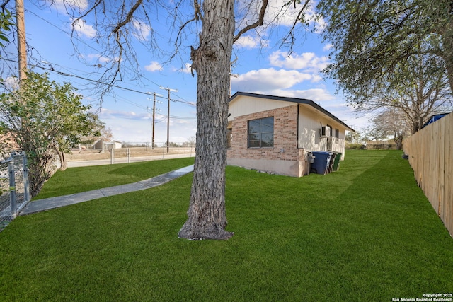 view of side of home with a yard