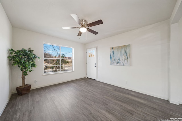 empty room with ceiling fan and dark hardwood / wood-style floors