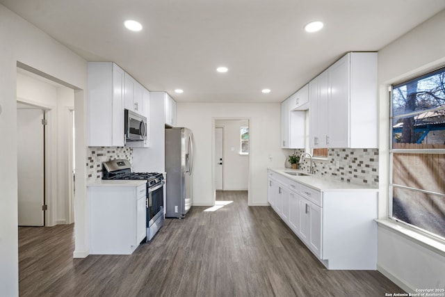 kitchen featuring white cabinets, stainless steel appliances, and dark wood-type flooring