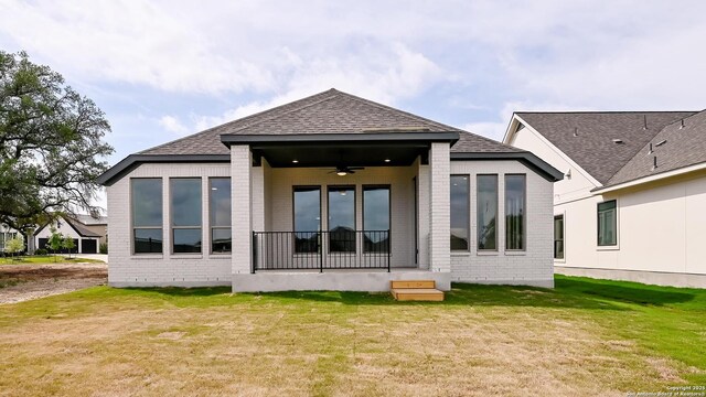 606 Inner Path, New Braunfels, TX 78132 - back of house with a lawn, ceiling fan, roof with shingles, and brick siding