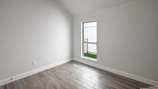 606 Inner Path, New Braunfels, TX 78132 - spare room with baseboards, wood finished floors, and lofted ceiling