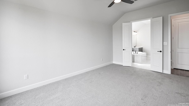 606 Inner Path, New Braunfels, TX 78132 - unfurnished bedroom featuring ceiling fan, vaulted ceiling, carpet floors, baseboards, and ensuite bathroom