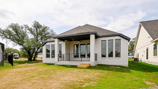 606 Inner Path, New Braunfels, TX 78132 - rear view of property featuring ceiling fan, central air condition unit, brick siding, a yard, and a shingled roof