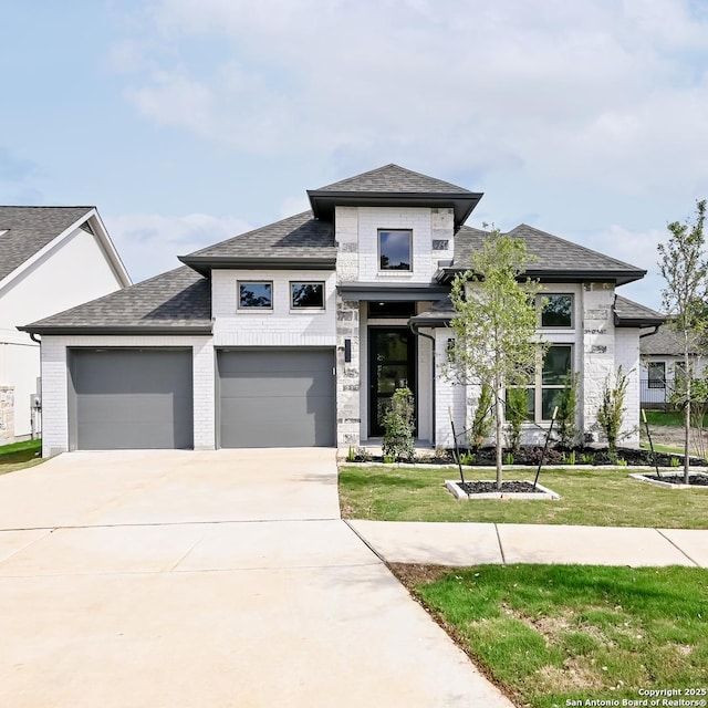 606 Inner Path, New Braunfels, TX 78132 - prairie-style home with driveway, a garage, brick siding, a front lawn, and a shingled roof