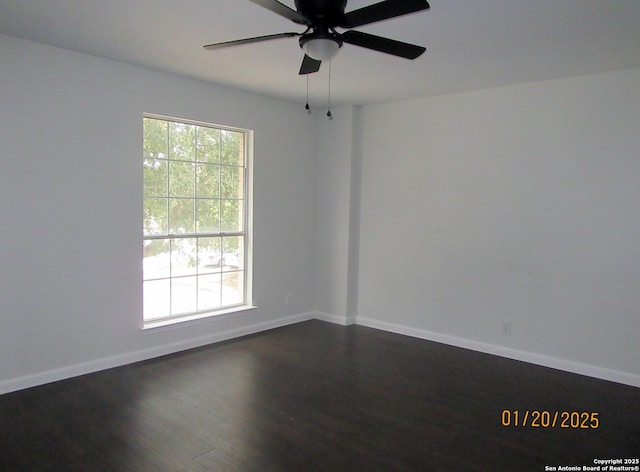 empty room with dark wood-type flooring and ceiling fan