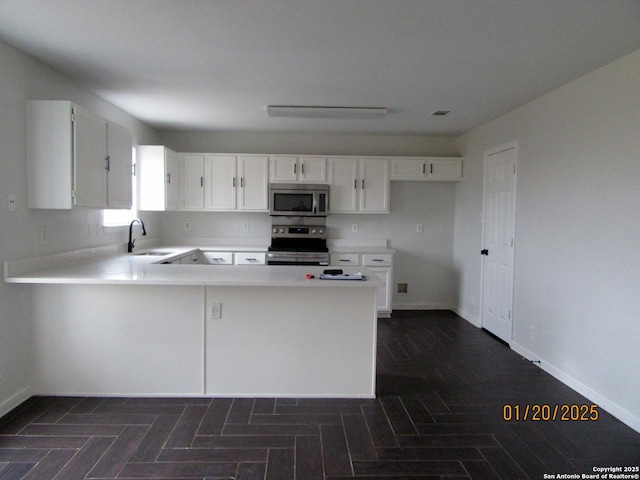 kitchen with sink, white cabinetry, and appliances with stainless steel finishes