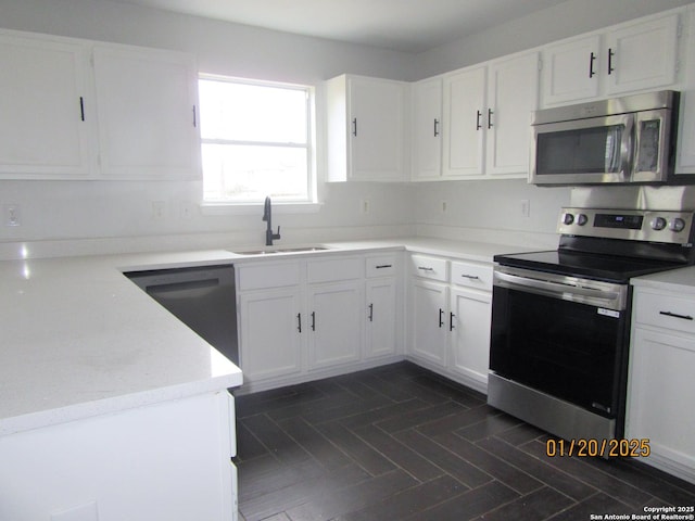 kitchen featuring sink, white cabinetry, and stainless steel appliances