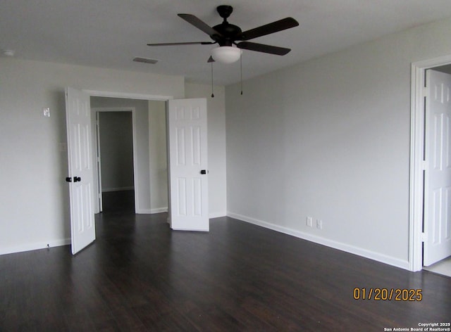 unfurnished room with ceiling fan and dark hardwood / wood-style floors