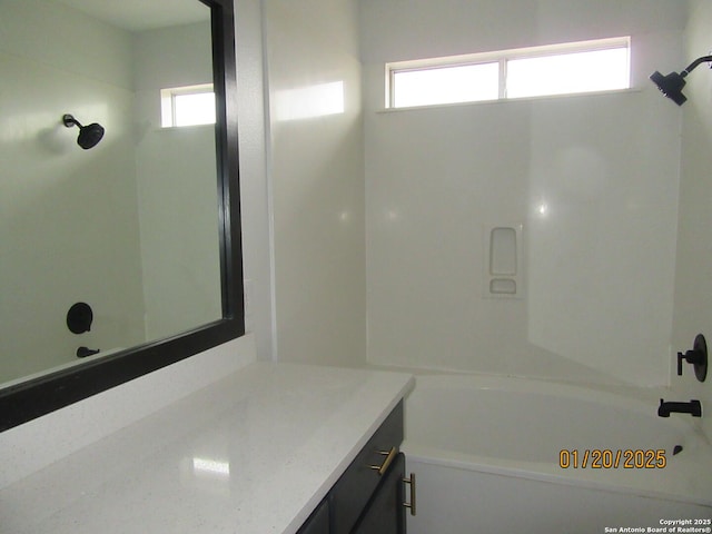 bathroom with plenty of natural light, vanity, and tub / shower combination